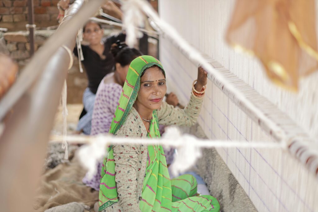 Traditional artisan weaving on a loom, showcasing textile craftsmanship and cultural heritage.